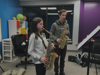 Two Orrett students playing saxophones together